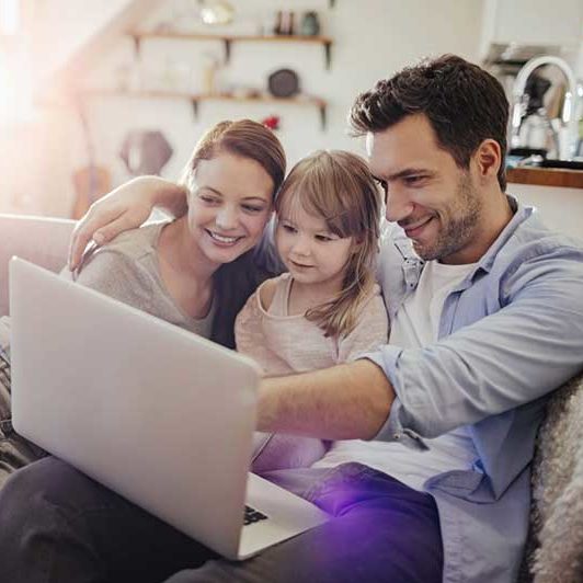 Family looking at a computer together 